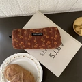 Brown corduroy pencil case with yellow floral pattern on a white decorative book - Brown Daisy