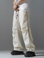 Detail of loose-fit off-white techwear pants featuring black side stripes and drawstring - Off White