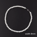 Detail of 8mm white faux pearl necklace with metallic lobster clasp on black background - 45cm / 8mm