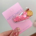 Pink heart glitter hair clip with banana resin charm on branded card display - Banana