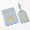 Close-up of light blue PU leather passport holder and luggage tag with gold world map stamp - Azure Map