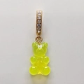 Detailed close-up of a fluorescent yellow resin gummy bear pendant with a gold rhinestone loop - Transparent Yellow