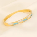 Macro detail of gold stainless steel eye bracelet with light blue enamel and zircon inlay - Long Ellipse Light Blue Enamel Zircon Style (7#)