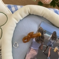 Close-up of amber acetate knot hair clip on textured blue fabric with natural lighting - Brown