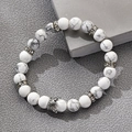 White turquoise 8mm beaded bracelet with silver crown pendant on a grey textured surface - White Howlite Silver Crown Style