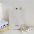 Detail of cream knitted phone bag with silver snap button and minimalist logo tag - Beige
