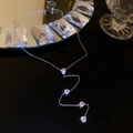 Detail of silver Y-shaped necklace with four round zircons and a teardrop pendant - Silver