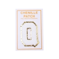 Detail of chenille letter Q patch with gold glitter border and self-adhesive backing - Letter Q / White