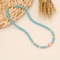 Detail of turquoise beaded necklace with owl pendant and gold lobster clasp - Turquoise/Copper