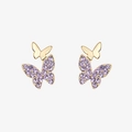 Detailed close-up of golden butterfly earrings with purple crystals and polished finish - Purple