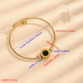 Gold stainless steel wire rope open bangle with a black roman numeral center piece - Cable Gold Black Shell Roman Numeral