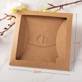 Square 15x15cm kraft paper packaging box with circular cutout on marble background - Kraft Windowed Style / Square