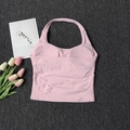 Detailed flat lay of pink halter yoga tank top with seamless ribbed texture and pads - S / Pink