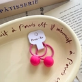 Pair of cute pink children hair ties with ball beads on a cream decorative plate - Pink