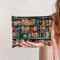 Detail of large canvas pouch with vintage bookshelf print held in hand with zip closure - Vintage Bookshelf Style