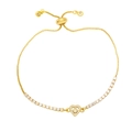 Detailed view of golden heart tennis bracelet with sparkling cubic zirconia and slider clasp - White