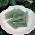Macro shot of rectangular green quartz stone pendants with drilled holes for DIY jewelry - Green Aventurine
