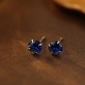 S999 silver stud earrings featuring deep blue round-cut gemstone in a four-claw setting - September Sapphire