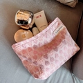 Pink canvas makeup bag with heart and bow patterns in a top-down view for travel storage - Pink Heart
