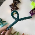 Detail of a large 11cm dark green hair claw clip showing the sturdy golden metal spring - 11cm / Malachite green