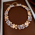 Detail of a golden leaf necklace with white pearls presented in a velvet jewelry box - 28# Necklace-Gold-Flower