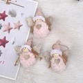 Pink plush angel Christmas ornaments with gold glitter wings on a soft white fur rug - 37 Winged Doll Pink