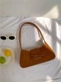 Brown leather baguette shoulder bag with a bow accent and stylish curved design - Brown