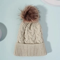 Cozy knit cable hat in oatmeal white featuring a large fluffy brown faux fur pom pom - One Size / Khaki