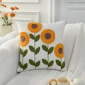 Modern white square cushion cover with orange sunflower embroidery on a white sofa - Row of Sunflowers (Cover Only)