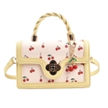 Bolso bandolera rosa con estampado de cerezas, asa amarilla y cierre de flor - Amarillo