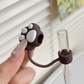 Close-up of brown paw silicone straw topper on glass straw in bright lifestyle setting - Cat Paw Brown / 10mm