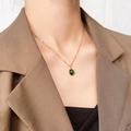 Exquisite 18k gold plated titanium steel necklace with a deep green opal pendant on neck - Emerald Green Cat Eye Stone