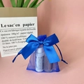 Blue organza gift bag with ribbon drawstring closure and decorative white bottles - Sapphire Blue