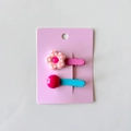 Detail of cute flower and bead hair clips on pink display card for young girls - Checkerboard Flower / Pink Plaid
