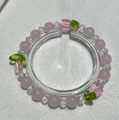 Exquisite beaded bracelet with pink round beads and green leaf charm on white fabric - S025 - Pink Tulip Bracelet #sz214