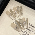 Macro shot of long trapezoid cat-eye press-on nails with sparkling rhinestones and pearls - Stiletto Style 2658 / Extra Small (XS)