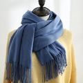 Soft bright blue cashmere-like scarf with fringe detail shown on a yellow knit sweater - Peacock Blue
