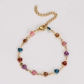 Detailed shot of golden link bracelet with thirteen multi-color glitter heart charms - 18+5cm / Multicolor