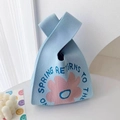 Light blue knit handbag with pink flowers and spring slogan in a woven style - Blue Sunflower