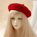 Classic bright red wool beret for women shown on a model head for a stylish winter look - One Size / Red