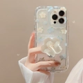 Close-up of floral iPhone case with 3D flower grip and blue blossom print detail - Blue White Flowers + Yellow Flower Bracket / iPhone 15 Pro Max