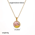 Detail of gold chain necklace with pink enamel pendant showing moon and star patterns - Pink Star Moon Round Style (TN3673-PK)