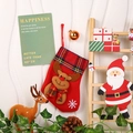 Close-up of red felt Christmas stocking with reindeer plush and festive decorations - Checkered Sock - Reindeer