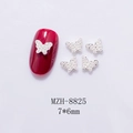Macro detail of 7x6mm mini metal butterfly nail charms with pearls on burgundy nail - Silver Butterfly With Pearl (8825)