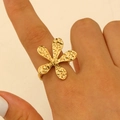 Exaggerated gold stainless steel ring with hammered flower design worn on model finger - Gold (4256)