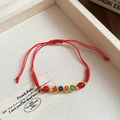 Bracciale intrecciato rosso regolabile con quattro perle dorate e caratteri portafortuna - Stile Perline Smaltate Pace e Gioia in Corda Rossa (14#)