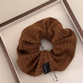 Detail of brown knitted scrunchie with cable pattern and Made in Korea label - Dark Coffee