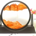 Circular hourglass sand art decor with orange sand and black frame on white desk - 12 Inch Stand Yellow