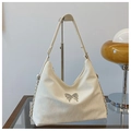 White soft leather shoulder bag with silver butterfly buckle detail on metal display stand - Off White