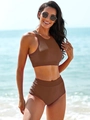 Detail of high-waisted brown two-piece sporty swimsuit set with smooth fabric on the beach - Coffee